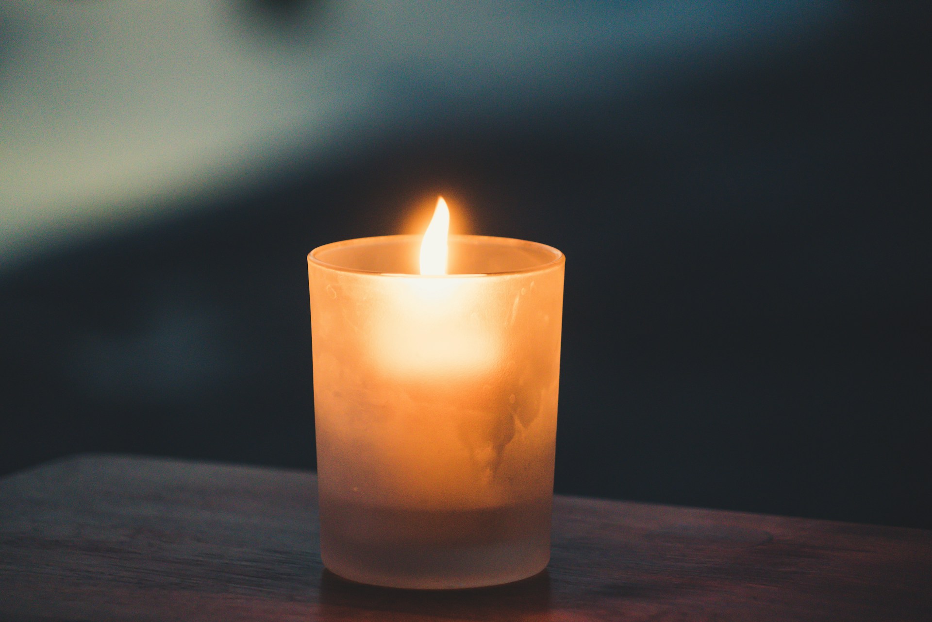 A lit candle on a table