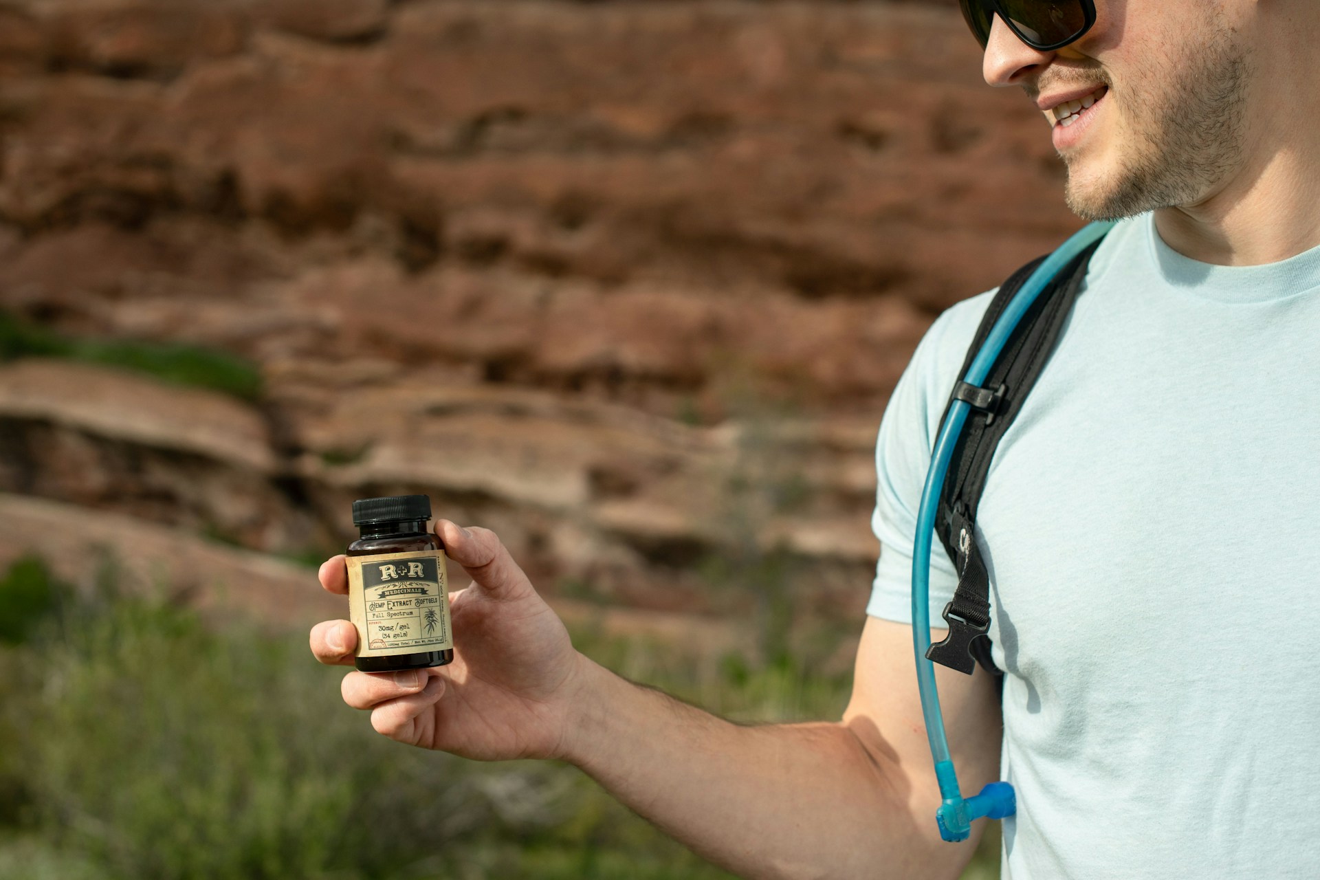 A man holding a black bottle