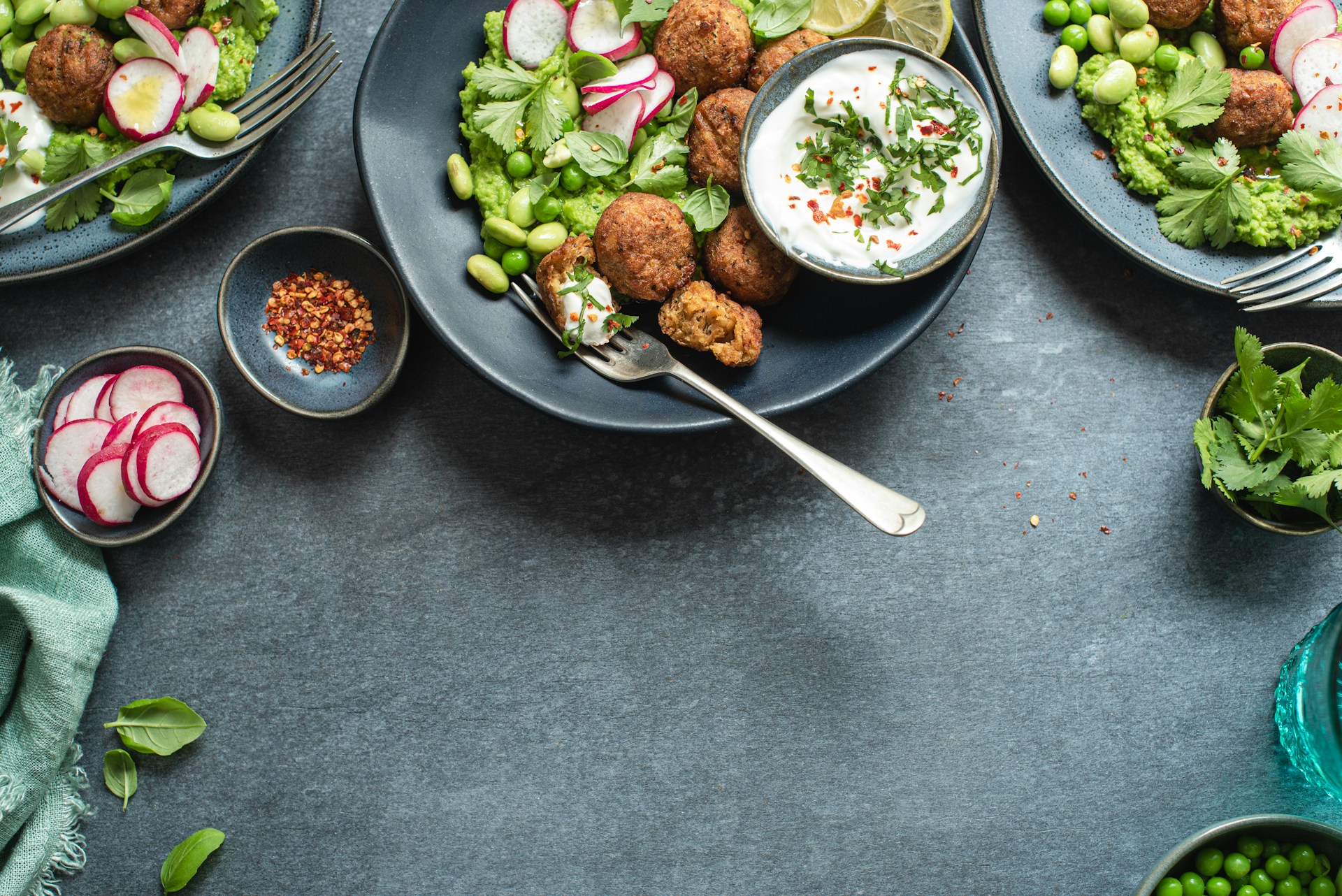 A table topped with plates of food