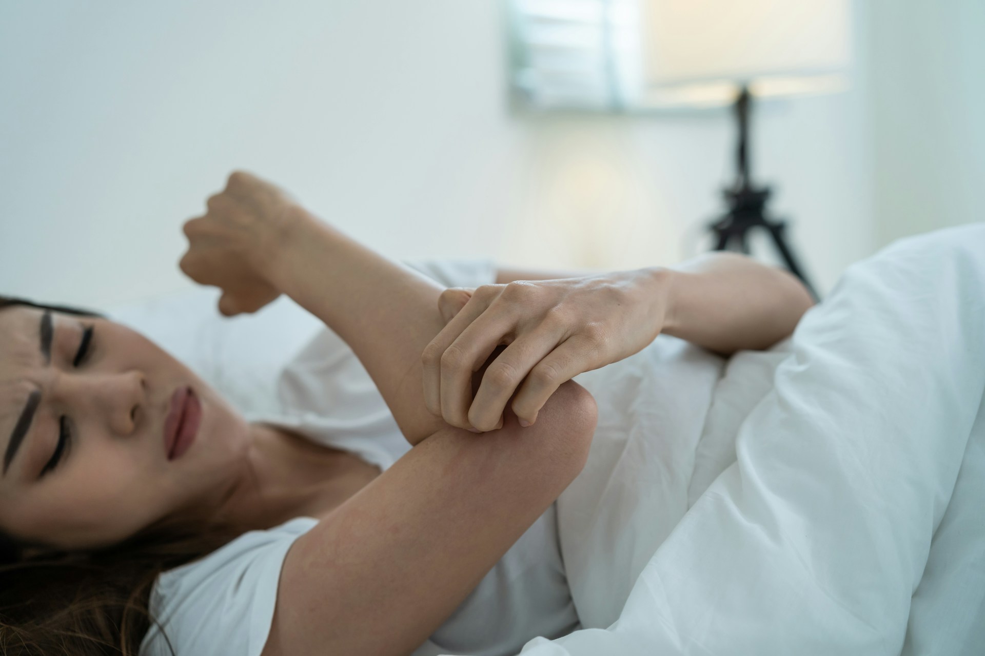 A woman scratching her hand