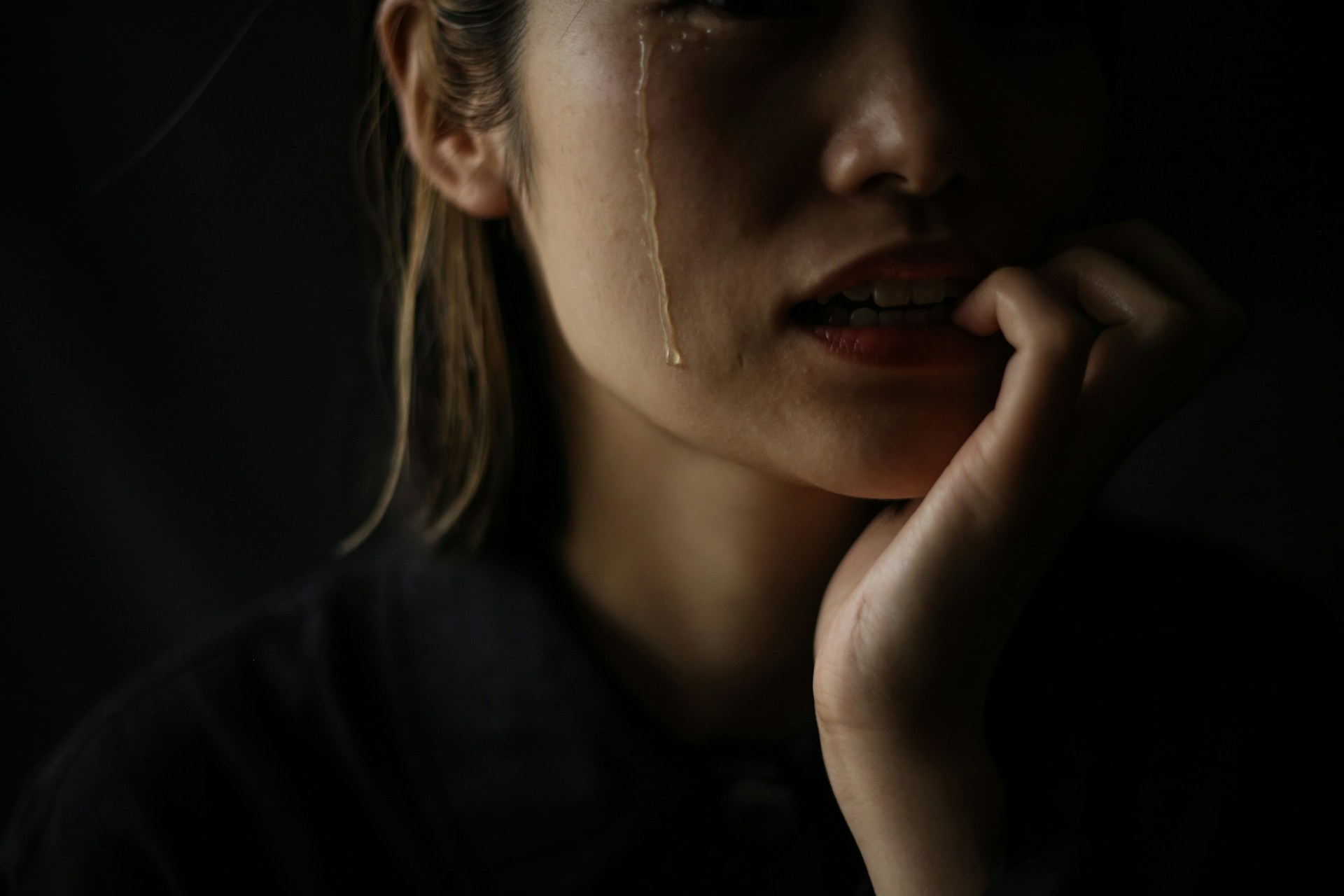 A woman who bites her nails while crying