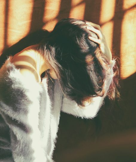 A woman holding her head