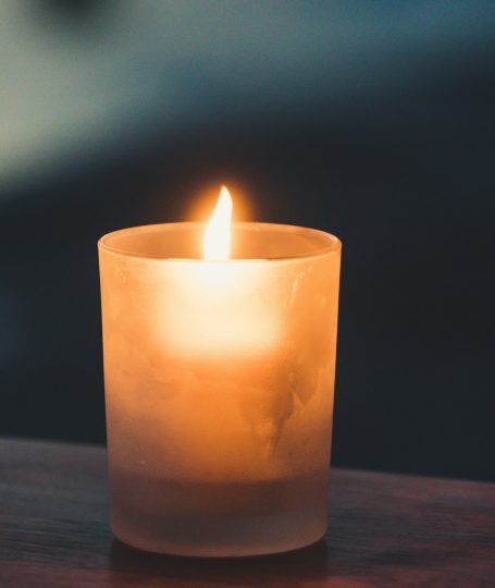 A lit candle on a table