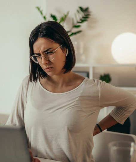 A woman holding her back