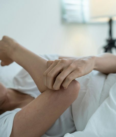 A woman scratching her hand