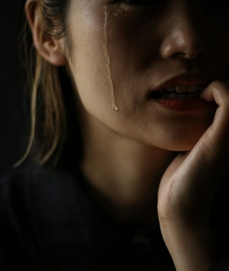 A woman who bites her nails while crying
